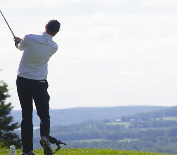 man playing golf looking out over the horizon